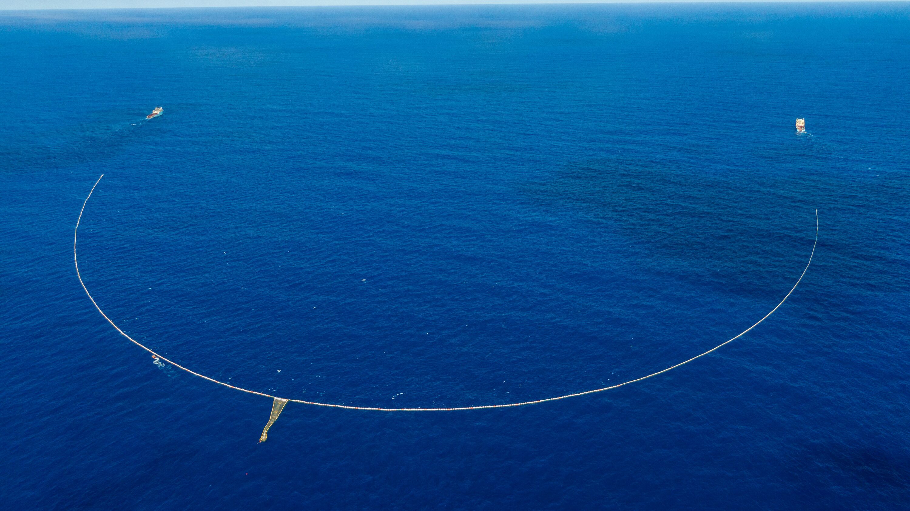 A picture of the System 03 owned by The Ocean Cleanup organization conducting a clean up in the ocean.